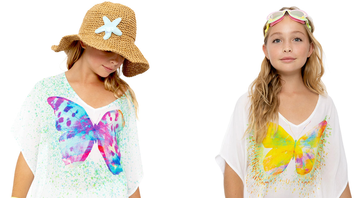 Two children wearing butterfly-themed t-shirts with different designs on a white background.